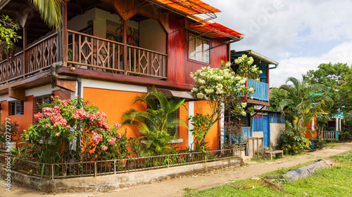 Colorful orange house and flower garden in El Castillo village along the San Juan river in Nicaragua