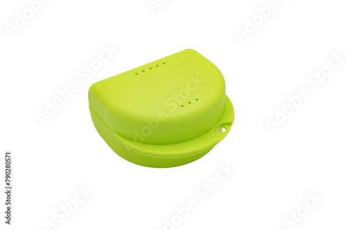 Detail of the classic lifelong orthodontic carrier box. This is a small greenish-yellow plastic box on a white background