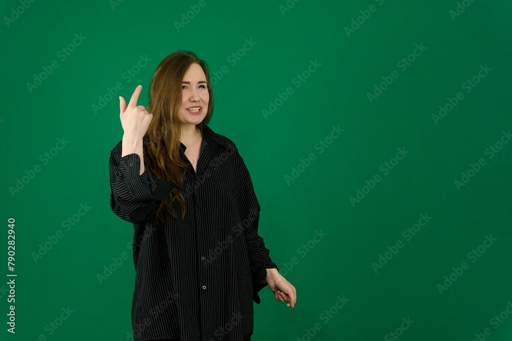 woman teenager in studio photo with green background doing poses. facial expressions