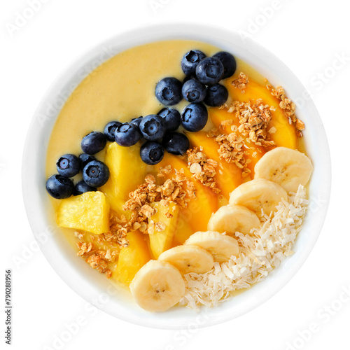 Healthy pineapple, mango smoothie bowl with coconut, bananas, blueberries and granola isolated on a white background