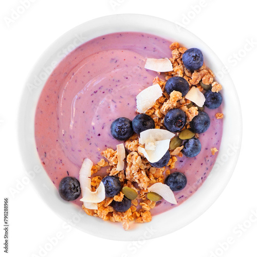 Healthy blueberry smoothie bowl with coconut, pumpkin seeds and granola isolated on a white background