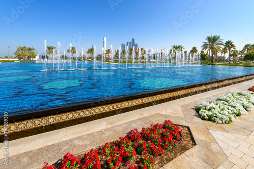 View of the modern Abu Dhabi skyline from one of the four large water features at the Qasr Al Watan Presidential Palace in Abu Dhabi, United Arab Emirates. photo