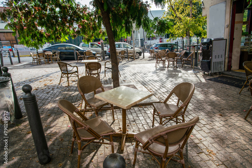 Tables nad chairsof streeet cafe in Marselle - summer finishing photo