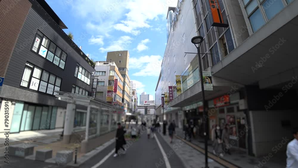 SHIZUOKA, JAPAN - MARCH 2024 : Cityscape of Shizuoka city in daytime. View of street at downtown area near Shizuoka train station. Time lapse shot. Blurred video. SHIZUOKA, JAPAN - MARCH 2024 : Cityscape of Shizuoka city in daytime. View of street at downtown area near Shizuoka train station. Time lapse shot. Blurred video.