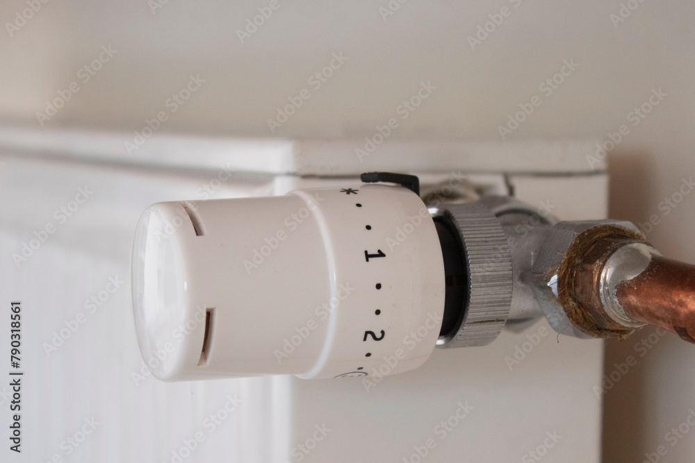 Adjusting the radiator temperature using a thermostat in an apartment with central heating