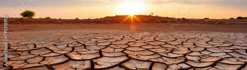 Driedup lake bed, cracked earth visible, under a scorching sun, symbolizing the severe impacts of global warming on natural resources photo