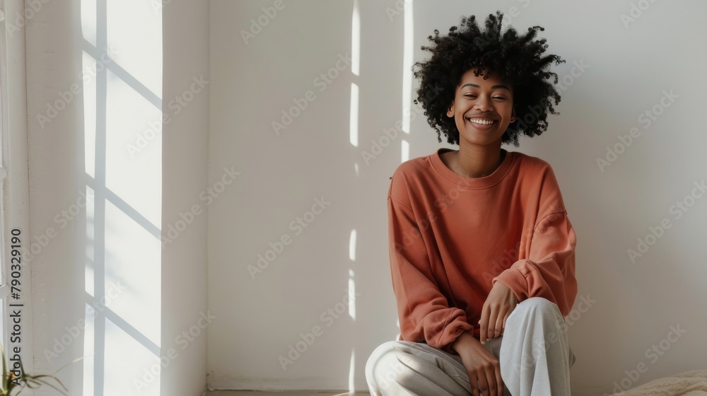 Woman Sitting on Bed Smiling at Camera