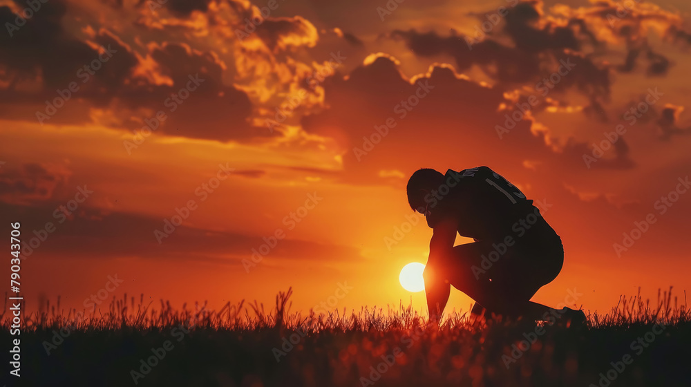 Fototapeta premium Football Player Contemplating at Dusk Silhouette