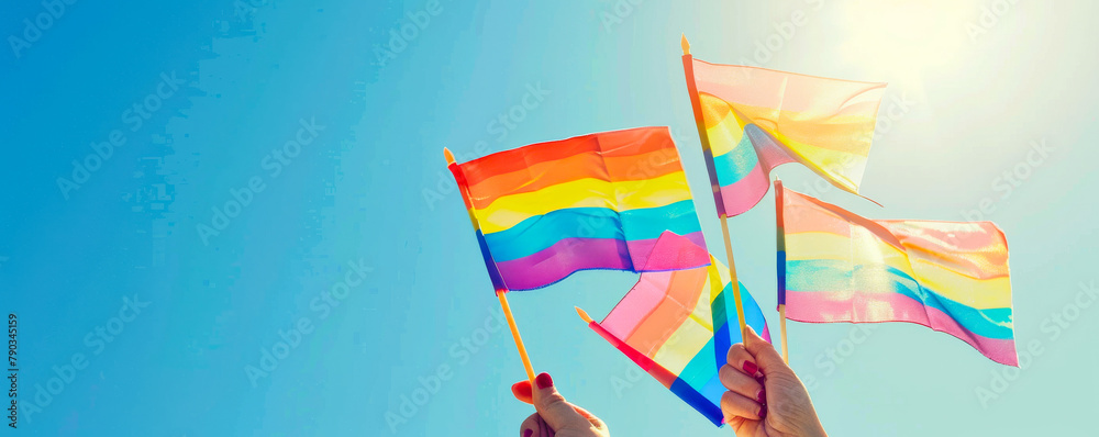 Small Rainbow Flags Against Blue Sky for LGBTQ+ Pride Support

