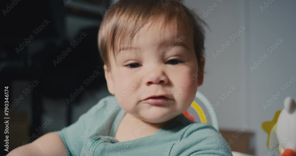 Baby boy making funny faces playing in his activity center Baby boy making funny faces playing in his activity center