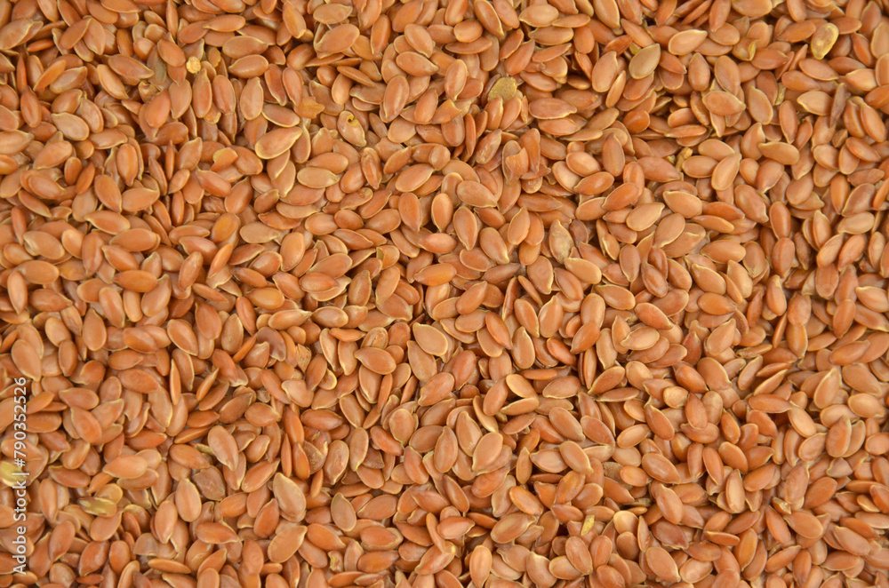 Fototapeta premium Flax seeds (linseeds) background, closeup, top view