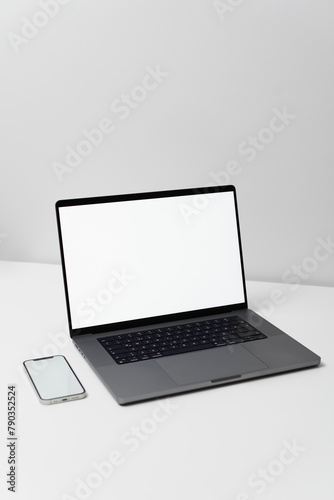 macbook laptop with white screen on a white table with white background, laptop screen mocap
