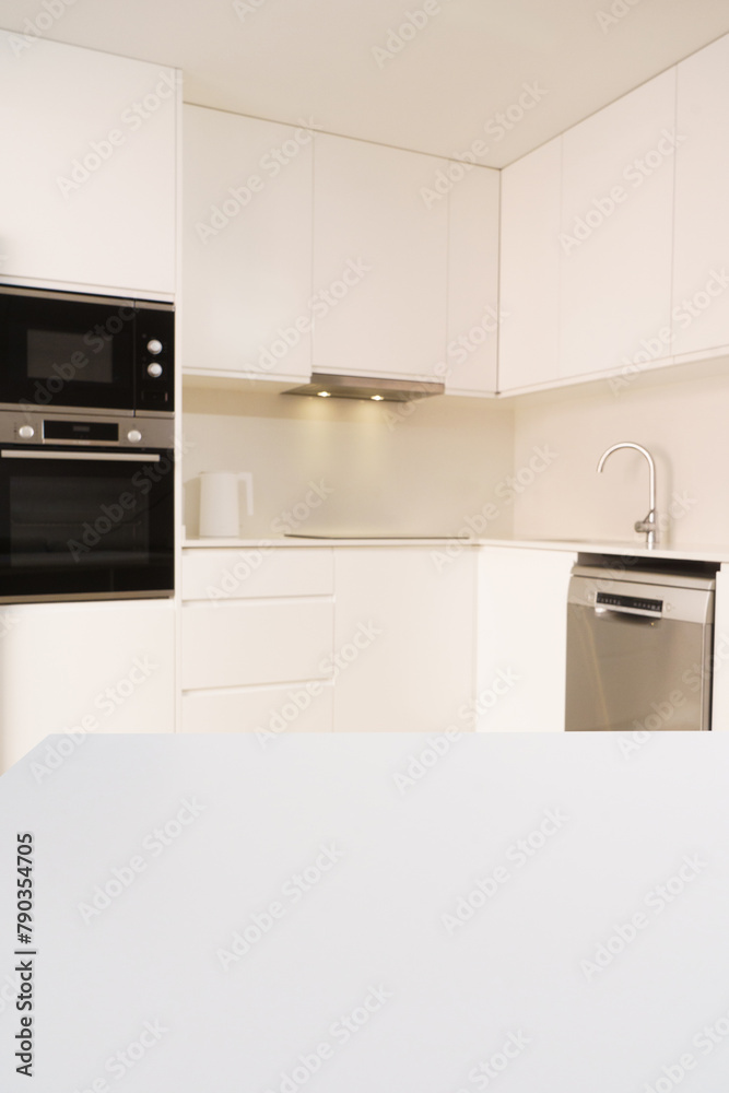 white table on the background of a white kitchen, background for placing a product on it white table on the background of a white kitchen, background for placing a product on it