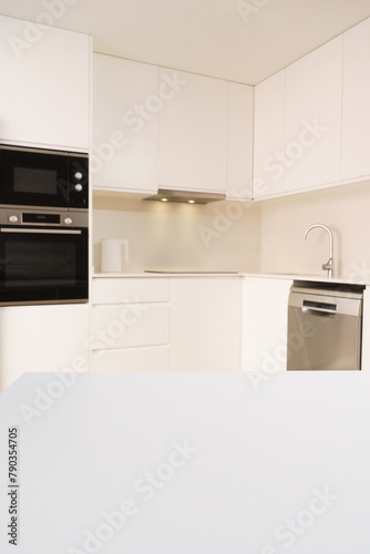 white table on the background of a white kitchen, background for placing a product on it