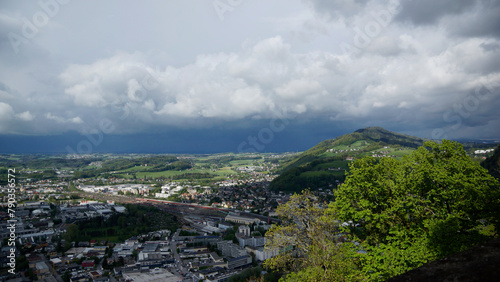 Blick auf den Güterbahnhof vom Kapuzinerberg in Salzburg mit tief dunklen Regenwolken photo