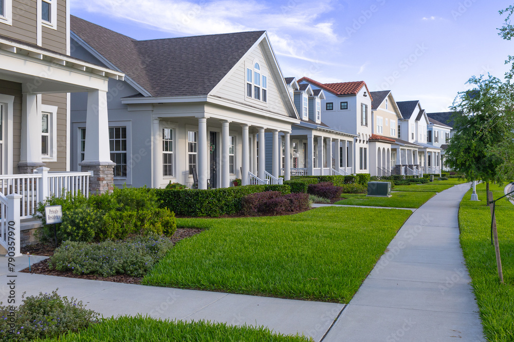 American houses and pedestrian path in summer