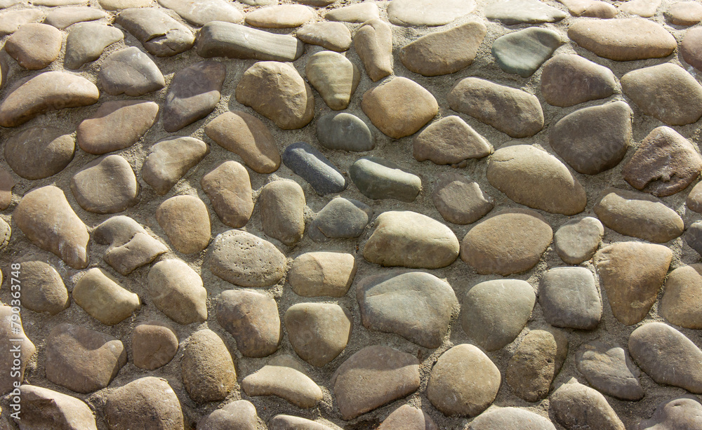 Abstract background with round pebble stones. Wall round stone rock ...
