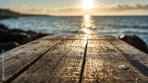 Sunrise over a calm sea viewed from a wooden pier photo