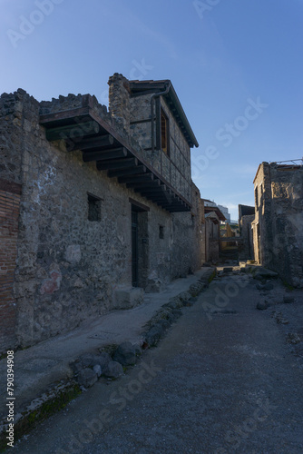 Roman street through the ruins during golden hour at sunset, Pompeii, Campania, Italy