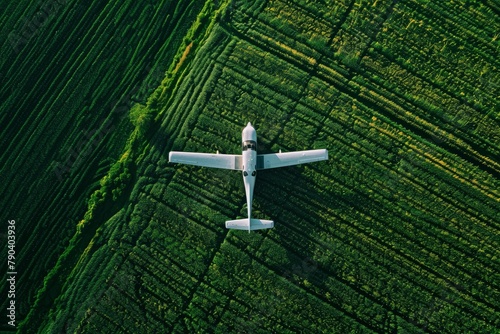 Aerial View of a Small Passenger Plane Flying Over Vibrant Green Farmland