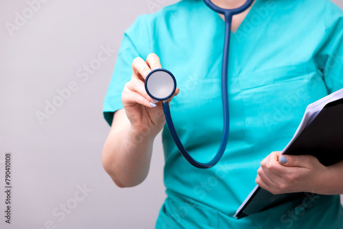 Female doctor holds stethoscope in hands closeup 