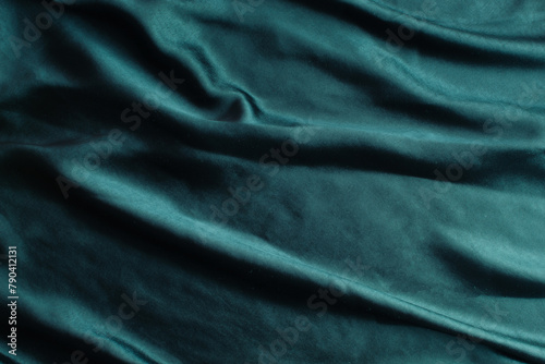 Smooth elegant dark turquoise blue satin texture can use as abstract background. Luxurious background design