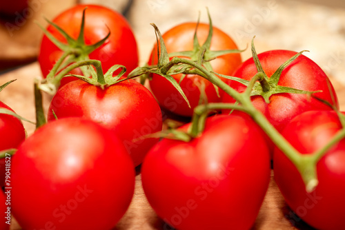 Organic red tomatoes on a vine © Pamela Au