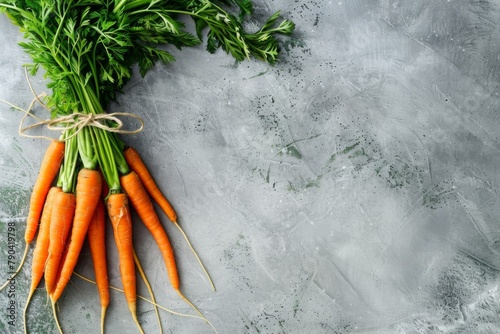 Fresh carrots with tops, a staple food ingredient in cuisine, displayed on table photo