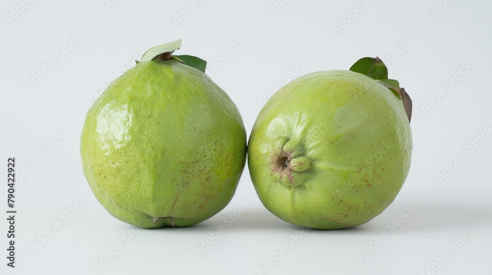 Two guavas displayed against a white backdrop Two guavas displayed against a white backdrop