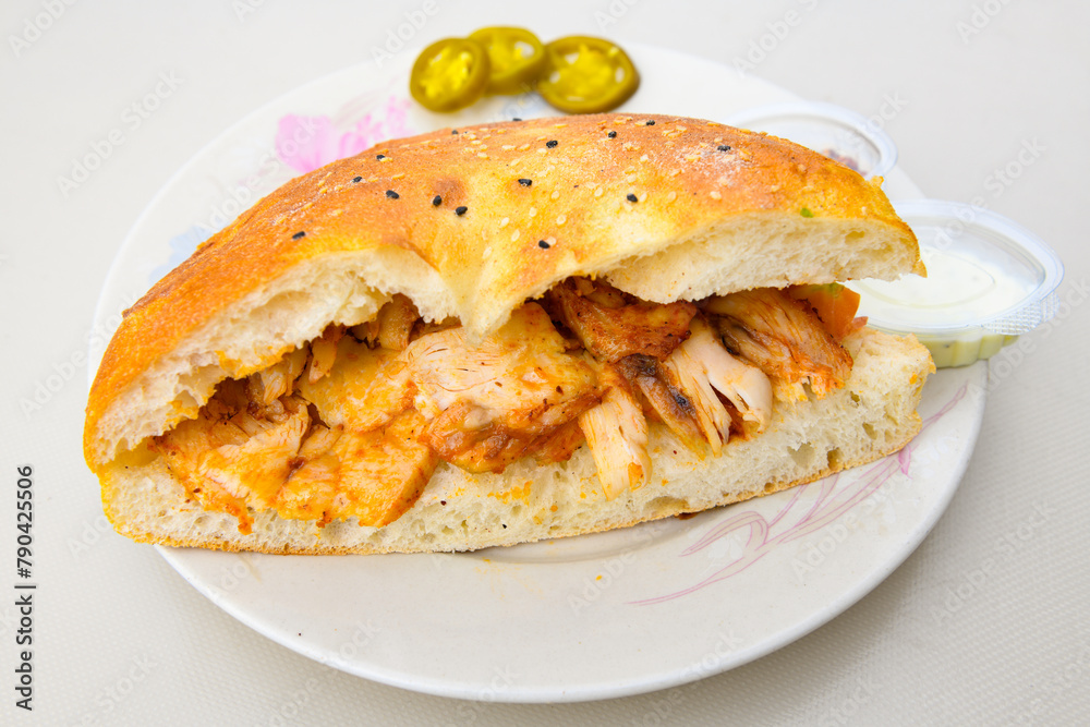 Turkish and Arabic Traditional Ramadan doner kebab with tasty tomato sauce and rice or turkish pilav in white plate on wood table background. ( Pilav ustu doner). Ekmek arasi doner, doner durum. Turkish and Arabic Traditional Ramadan doner kebab with tasty tomato sauce and rice or turkish pilav in white plate on wood table background. ( Pilav ustu doner). Ekmek arasi doner, doner durum.