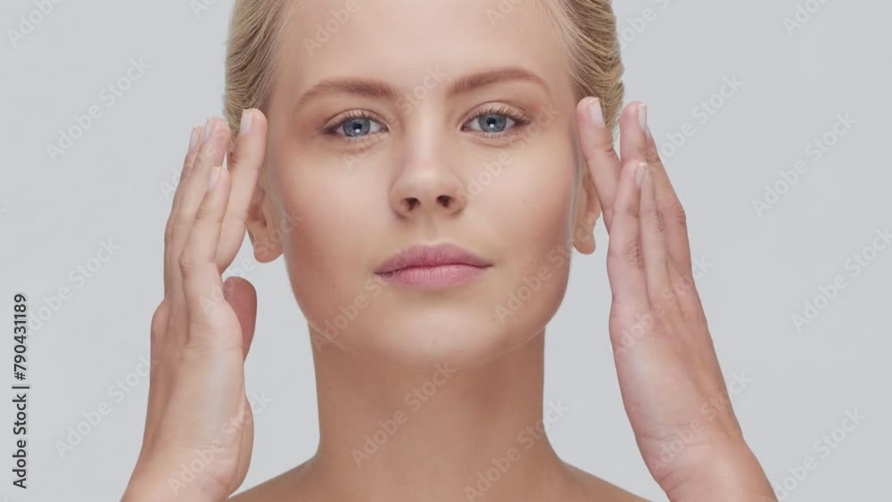 Studio portrait of young, beautiful and natural blond woman applying skin care cream. Face lifting, cosmetics and make-up concept. Studio portrait of young, beautiful and natural blond woman applying skin care cream. Face lifting, cosmetics and make-up concept.