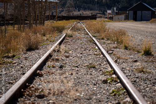 old rail line overgrown with grass in the mountains