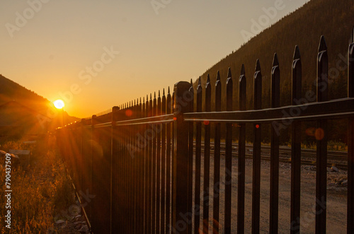 sunrise over a fence