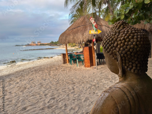 statue overlooking the beach