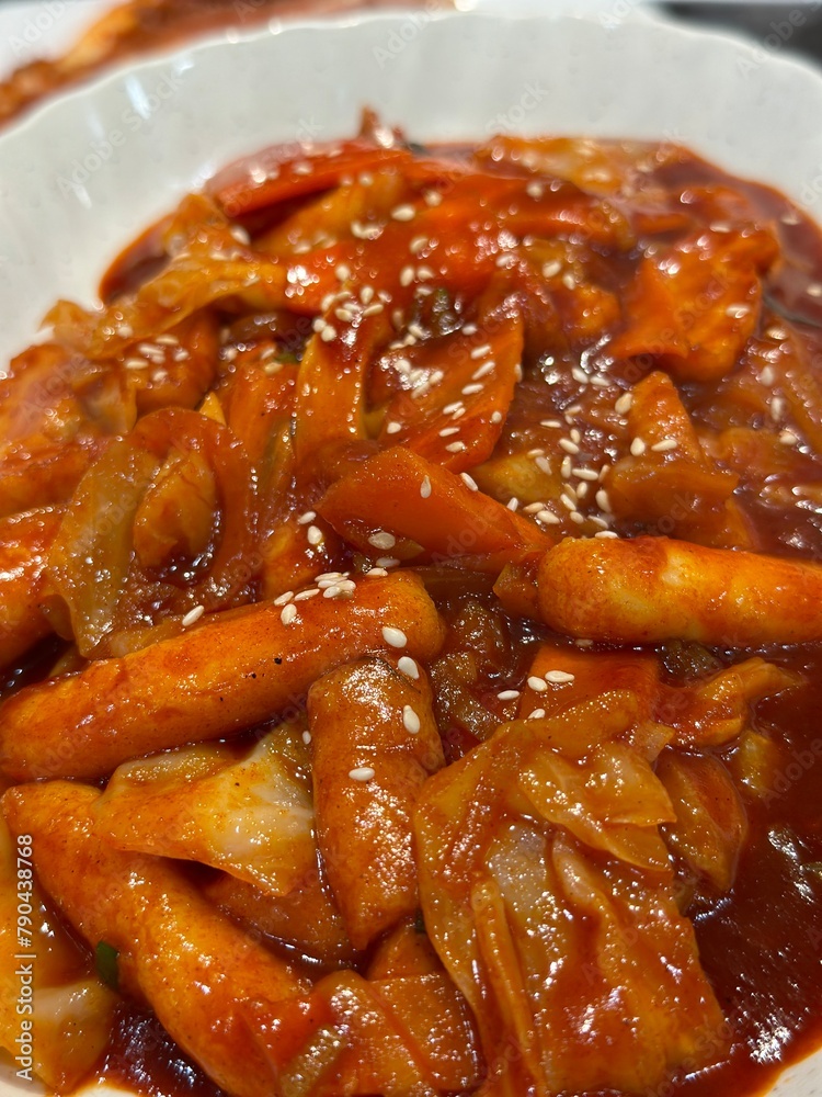 Tteokbokki is chewy rice cakes cooked in a red, spicy broth