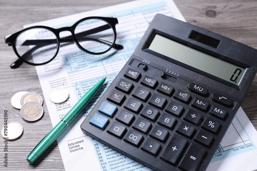 Tax accounting. Calculator, document, pen and coins on wooden table, closeup Tax accounting. Calculator, document, pen and coins on wooden table, closeup
