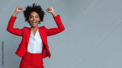 Buntu businesswoman wearing red formal suit, smiling and raised hands photo