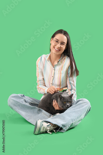 Young woman brushing cute B...