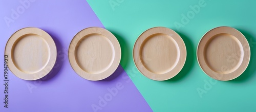 Three empty wooden plates arranged neatly on a textured blue and green background