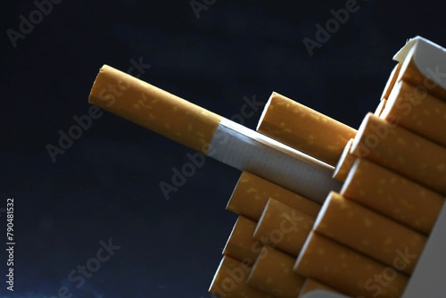 Have a cig, smoking cigarette concept Isolated on dark background  photo