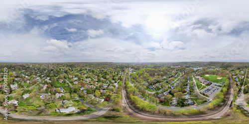 An aerial panorama over the vibrant community of Millburn, NJ. The image displays a rich tapestry of homes and nature, providing a glimpse into the diverse residential life of this charming area.