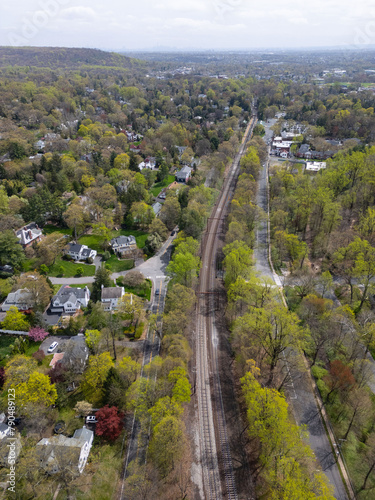 Captured from the skies, this drone image highlights the scenic railway stretching through Millburn, NJ, with the distant NYC skyline creating a striking contrast between urban and suburban landscapes