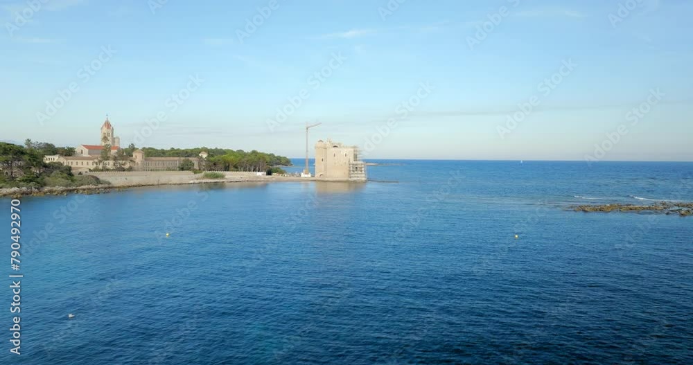 Aerial: An Ancient Castle Stands Guard By The Azure Sea, Its Stoic Walls And Timeless Architecture A Silent Witness To The Ebb And Flow Of Tides And Time. - Cannes, France Aerial: An Ancient Castle Stands Guard By The Azure Sea, Its Stoic Walls And Timeless Architecture A Silent Witness To The Ebb And Flow Of Tides And Time. - Cannes, France