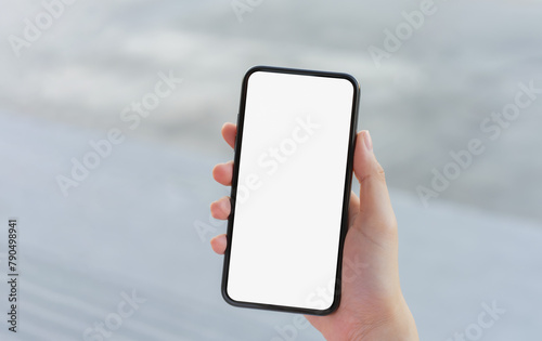 Hand holding smartphone mockup of blank screen, Take your screen to put on advertising.