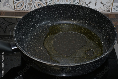 frying pan with vegetable oil on electric stove