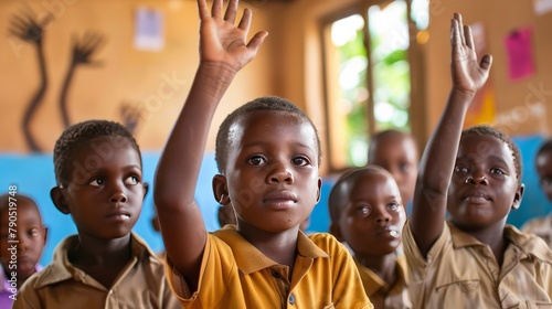 African children raising their hands in a classroom photo