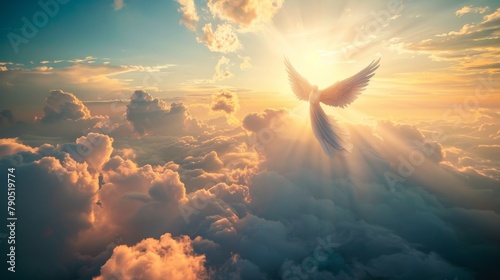 An angel flies in the sky above the clouds toward the sun. photo