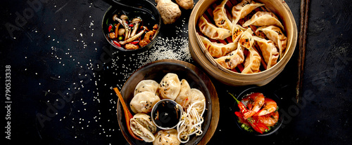 Chinese dumplings, soy sauce, mushrooms on dark background. traditional asian food concept