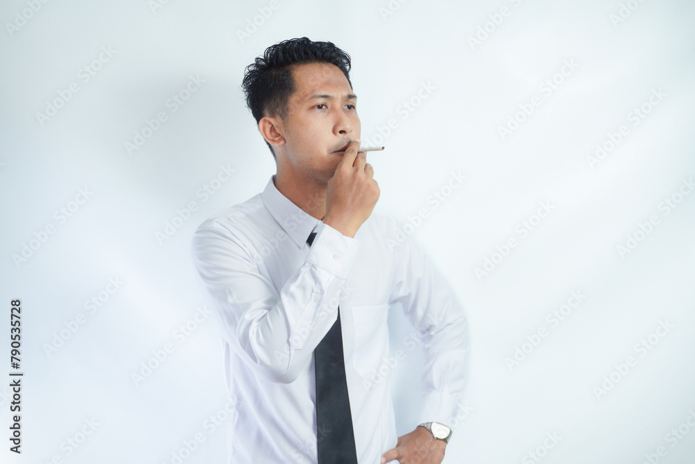 young handsome businessman smoking a cigarette young handsome businessman smoking a cigarette
