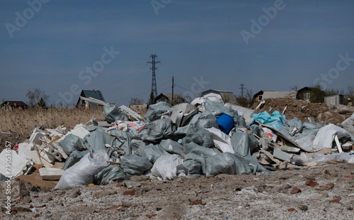 Pile of construction waste in front of an unfinished building. photo